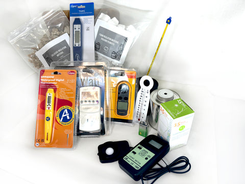 Image of School Energy Managers Kit pictured: 1 Light emitting diode bulb (LED)* 1 Kill A Watt® meter* 5 Sets of radiation cans (2 per set)* 10 Lab thermometers* 2 Bags of insulating materials (cellulose, packing peanuts) * 5 Boxes* 3 Student thermometers* 1 Light meter* 1 Waterproof digital thermometer* 1 Digital humidity/temperature pen (hygrometer)* 1 9-volt Battery (for light meter)* 1 Anemometer